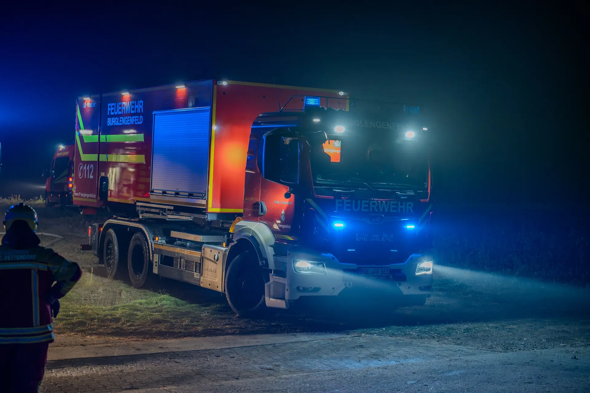 Feuerwehrfahrzeug mit Blaulicht bei Nacht